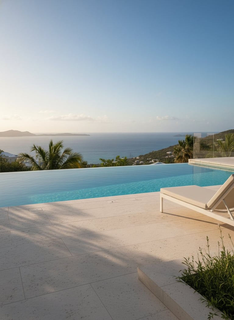 Modern infinity pool overlooking Mediterranean Sea with white lounger, palm trees, and mountain views at sunset